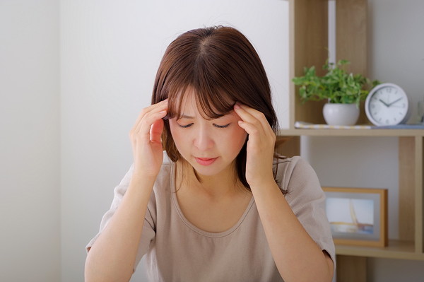 家事のストレスで頭を抱える女性